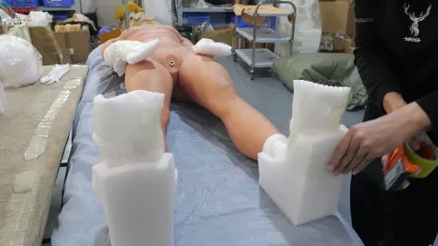 Finished doll protected with foam blocks at the factory before packing